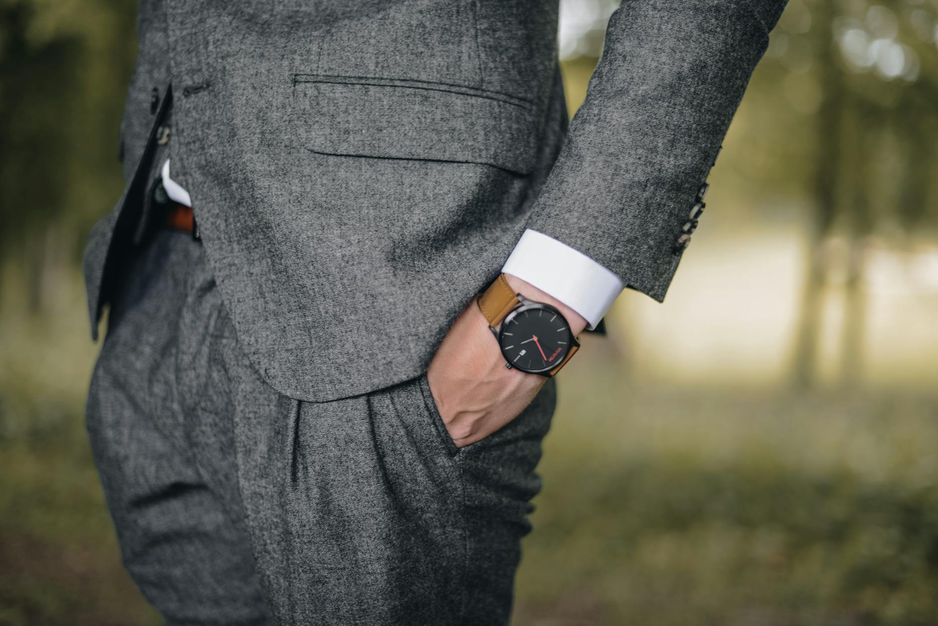 man wearing watch with hand on pocket